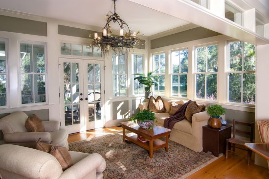 green sunroom with white windows