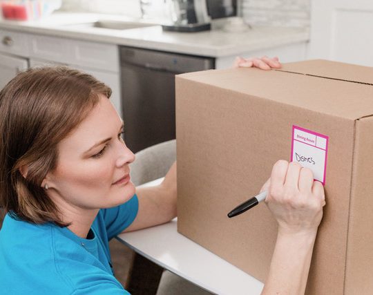 moving genie labeling a moving box