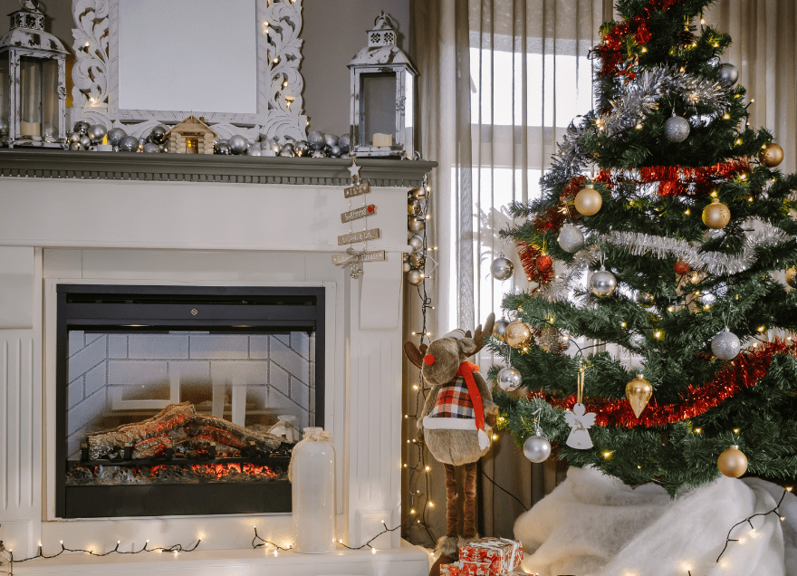living room with fireplace and holiday tree