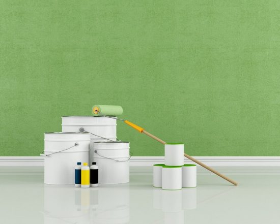 green wall painting with roller and cans