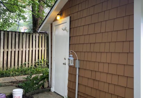 side of house with cedar shake siding and white trim