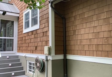 side of house with cedar shake siding and white trim