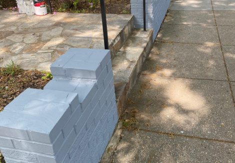 brick fence near sidewalk repainted gray to match house color