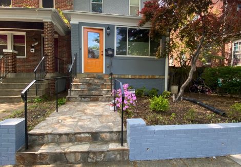 townhome repainted gray with orange door