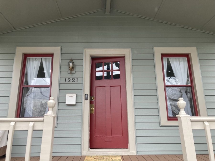 red front door on green house Preview Image 1