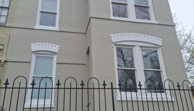 home exterior with painted brick and frence