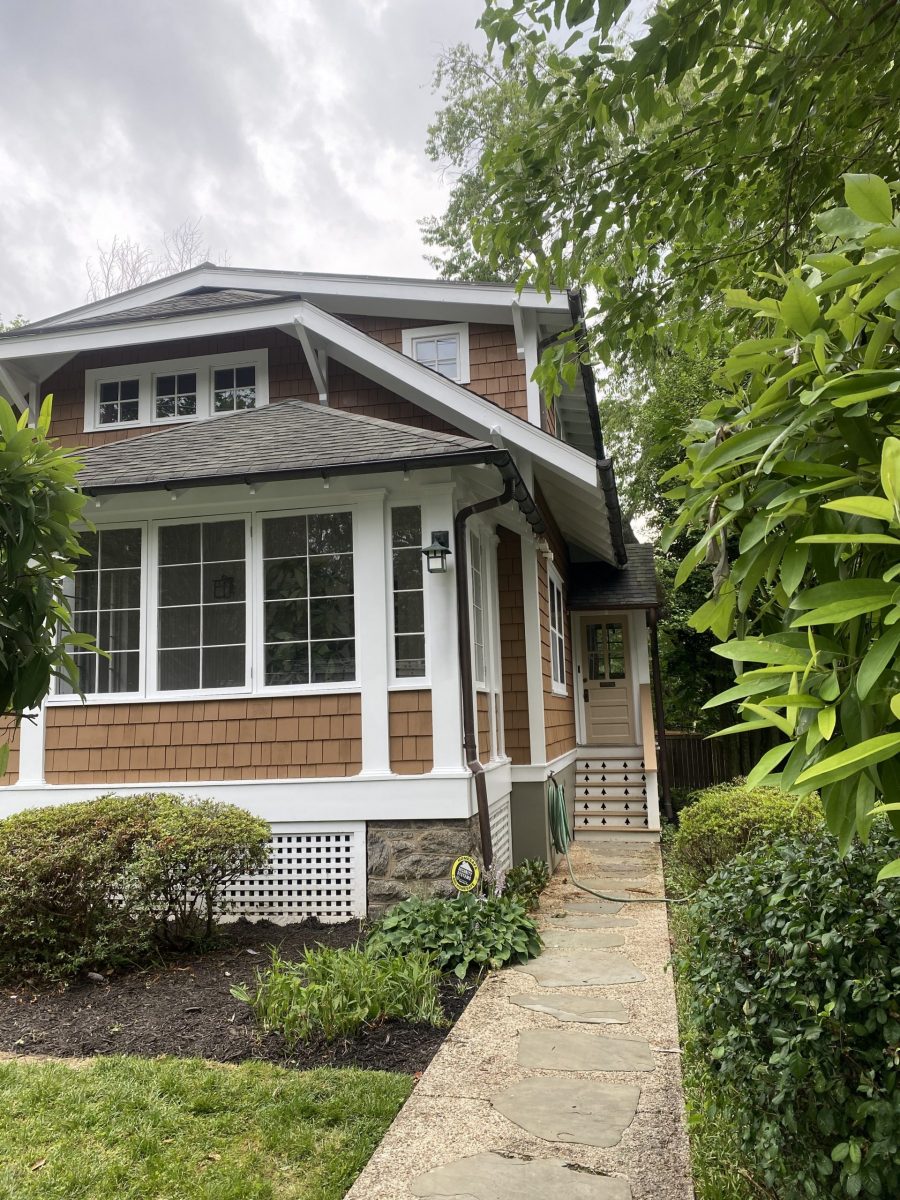 front of house with cedar shake siding and white trim