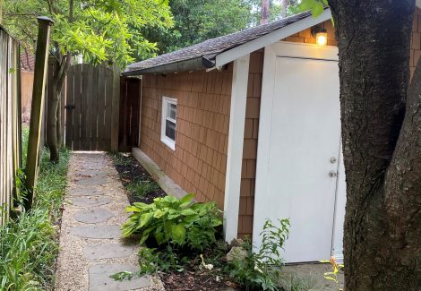 side of house with cedar shake siding and white trim