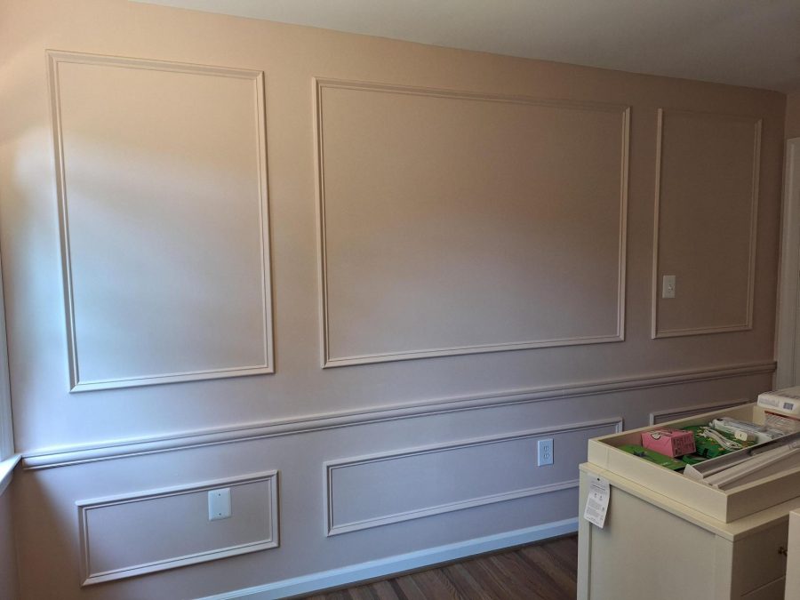 pink painted nursery wall with wainscoting trim