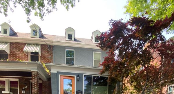 townhome repainted gray with orange door