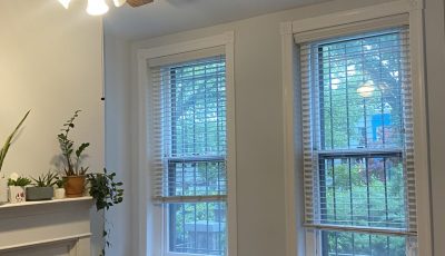living room interior with fireplace and front windows