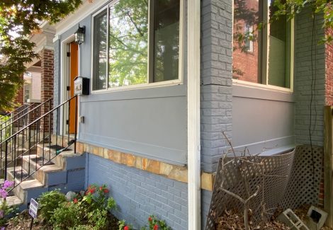 Side view of brick townhome repainted gray