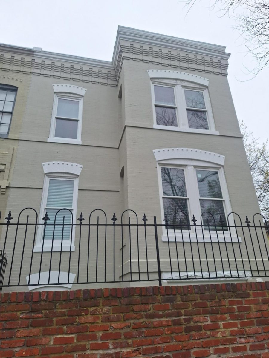 home exterior with painted brick and frence
