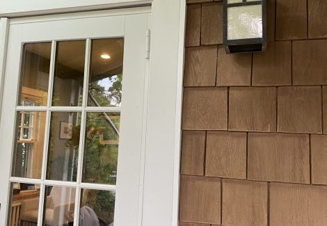 exterior door of house with cedar shake siding