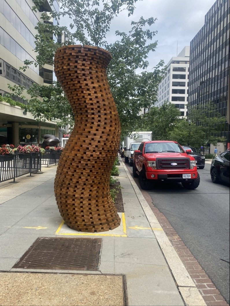 wooden art installation sculpture on city sidewalk Preview Image 2