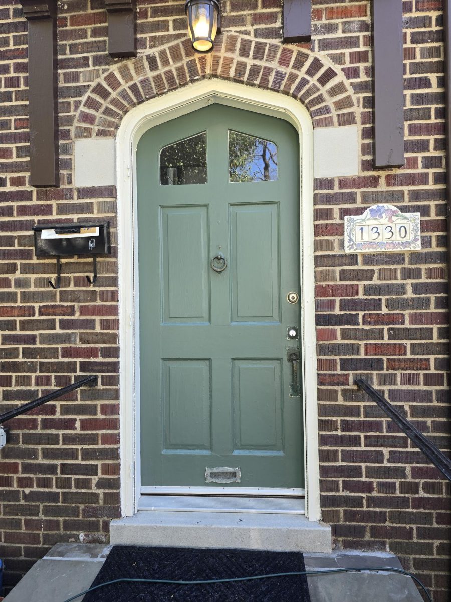 green arched door of brick house Preview Image 2