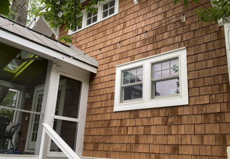 side of house with cedar shake siding and white trim