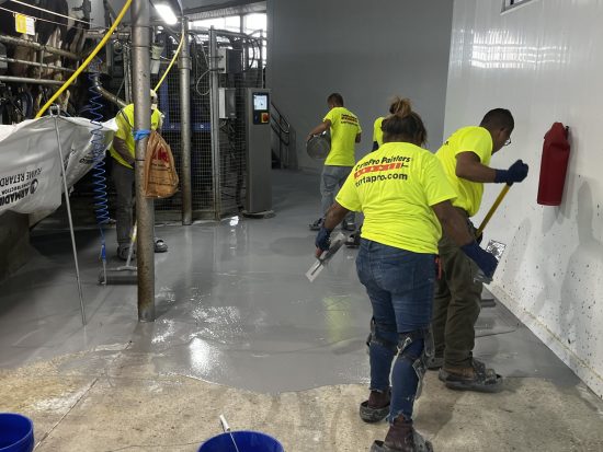 McCarty Farms Commercial Flooring Project spreading out product onto floors