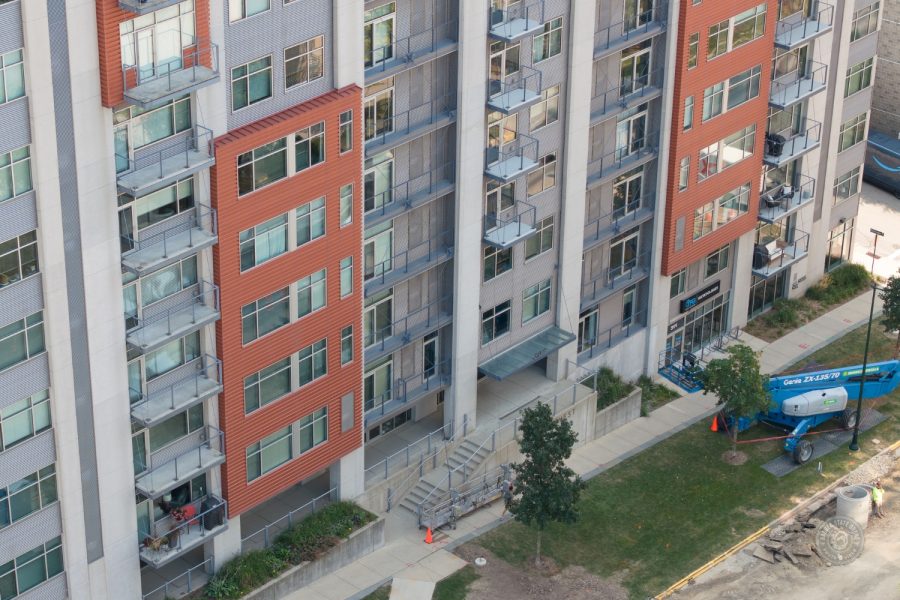 Condo Painting Project arial view of buildings side with boom lift in foreground Preview Image 6