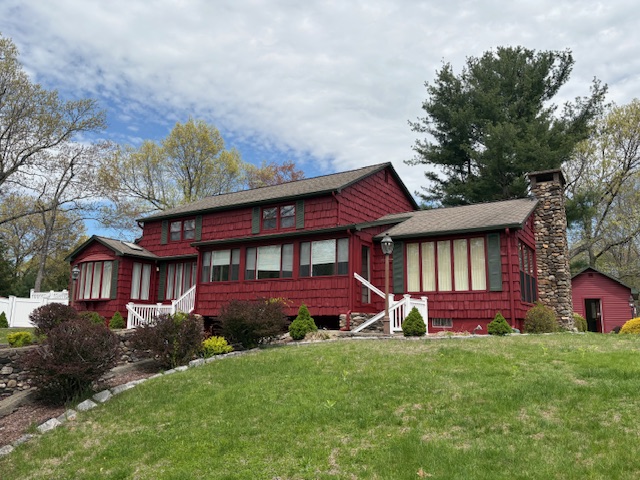 after photo of exterior of house painted red