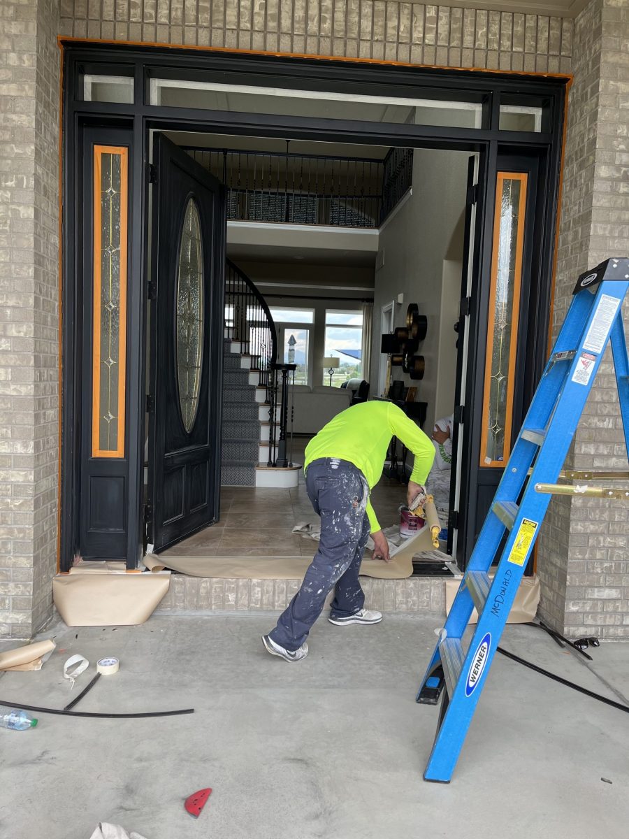 painter working on door frame of house Preview Image 3
