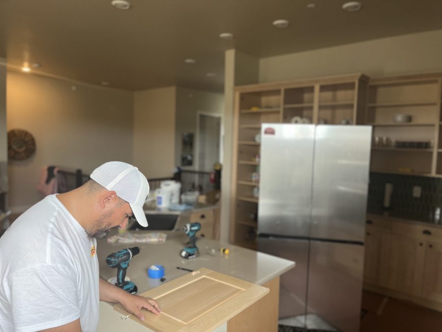 man working on cabinet door in kitchen Preview Image 4