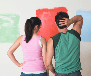 couple in front of interior paint colors samples