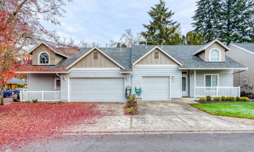 Full View - Light Grey Townhomes' with Tan Attics, a Dark Grey Roof & White Trim