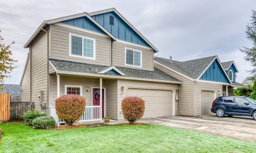 Lawn View - Tan Townhome with Blue Attics, a Dark Grey Roof & White Trim