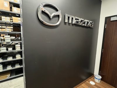 Mazda dealership wall with logo after completed commercial painting project by certapro painters of wilmington, nc