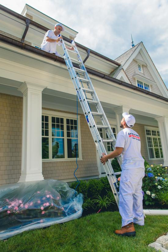 CertaPro Painters team working together on effective time schedule to repaint second-floor of residential home.