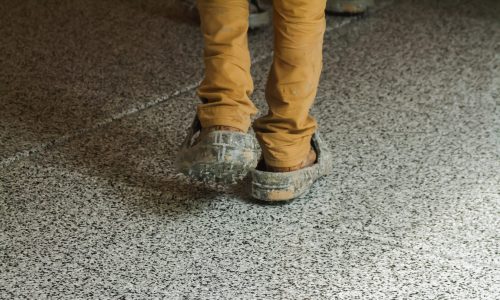 CertaPro Painters of Winston Salem wearing protective gear while applying epoxy to a garage floor.