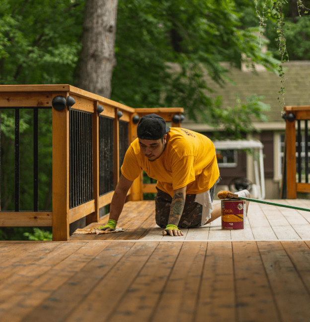 certapro painter staining a deck