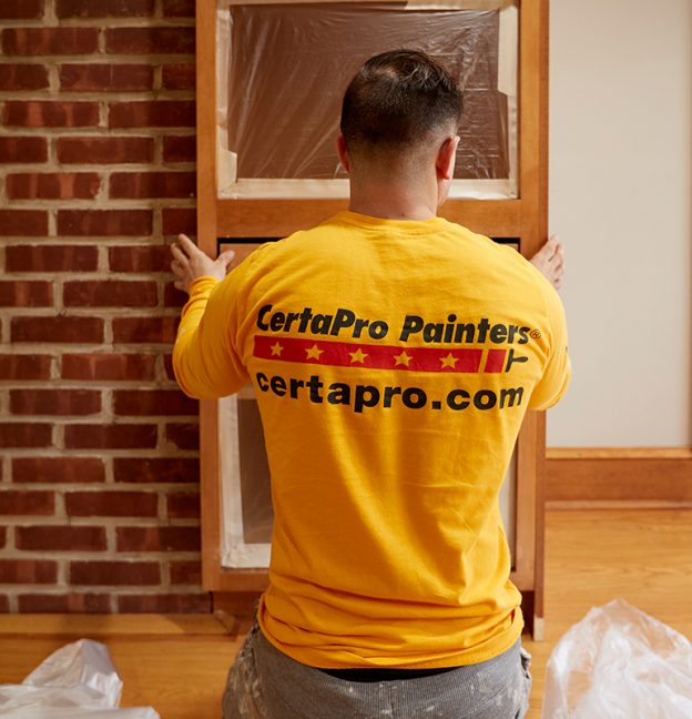 professional painter painting kitchen cabinets