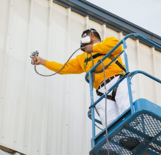 commercial painter painting an office building