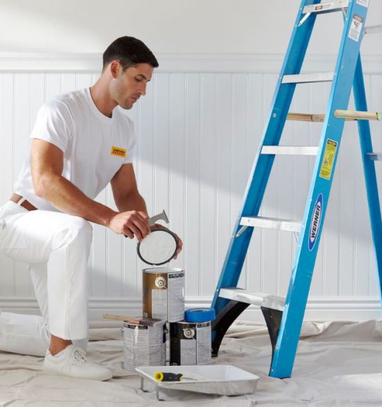 man painting commercial interior wall