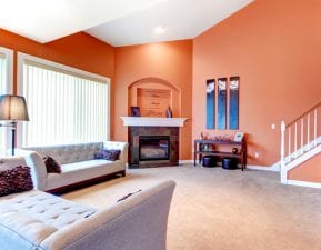 Living room with light orange interior paint color scheme.