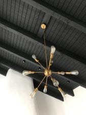 sputnik light fixture hanging from a black ceiling